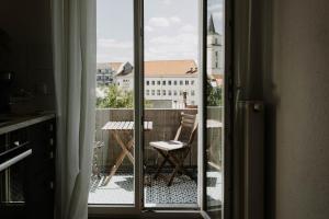 a view of a balcony with a chair and a table at Bauhaus Museum Apartment in Dessau