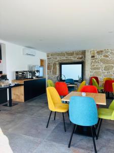 a dining room with colorful chairs and a table at Paços de Douro - Bedroom 5 Relaxation & Space in Romariz