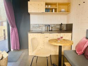 a small kitchen with a wooden table and a table at Dog friendly cabin & hot tub and Cairngorm views in Aviemore +15 photos