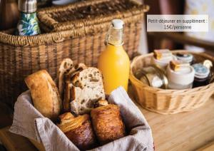 a basket of bread and a bottle of orange juice at Bulles d'Olive Provence avec piscine - Jacuzzi en option in Nyons