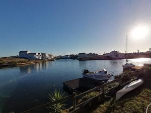 two boats are docked at a dock on a river at Skoenlapper holiday home in Velddrif