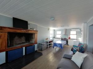 a living room with a couch and a table at Skoenlapper holiday home in Velddrif