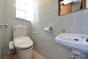 a bathroom with a toilet and a sink at Mensore Houese in Naha +68 photos
