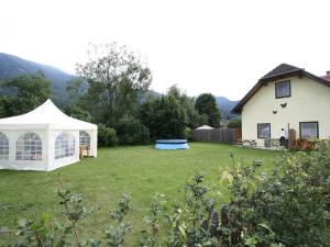 a gazebo in a yard next to a house at Apartment in St Michael near Ski Slopes in Sankt Michael im Lungau