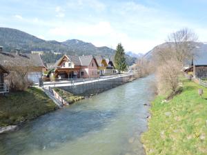 a river in a town with houses and buildings at Apartment in St Michael near Ski Slopes in Sankt Michael im Lungau +24 photos