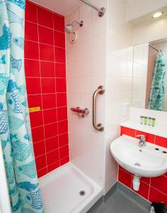 a bathroom with a sink and a tub and a shower at Lovely Modern Central Coventry Budget Studio in Coventry +9 photos