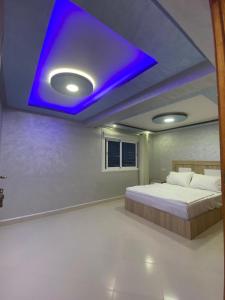 a bedroom with a bed with a blue ceiling at Résidence Assalam - en bord de mer in Azla +34 photos