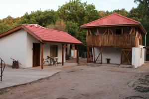 a small building with a red roof and a table at Ижата 2 in Borovitsa