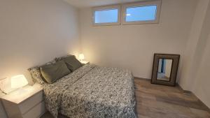 a bedroom with a bed and a mirror and a window at Vallgorguina Uno in Vallgorguina