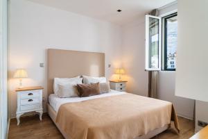 a bedroom with a large bed with two night stands at Golden escape in Funchal in Funchal