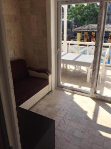 a room with a chair and an open door at Noo 15 in Side +2 photos