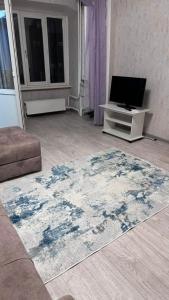 a living room with a rug on the floor at Однокомнатная Квартира в центре in Almaty