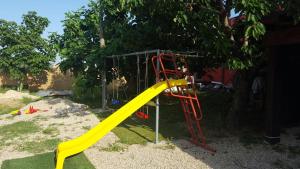 a playground with a yellow slide in a yard at B&B La Casa in Campagna in Collecorvino