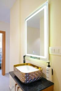 a bathroom with a sink and a mirror at Shreshtam Apart Hotel, Gachibowli in Hyderabad +50 photos
