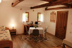 a living room with a table and a bed at Ижата 2 in Borovitsa