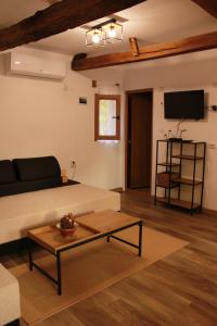 a living room with a couch and a coffee table at Ижата 2 in Borovitsa