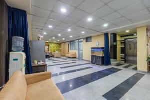 ニューデリーにあるHotel Aerostar Gold Near Yashobhoomi Conventioin Centerのソファと暖炉付きのオフィスロビー