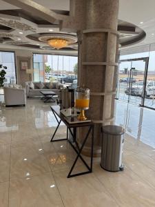 a lobby with a table with a drink on it at شقق أسس غين للشقق المخدومة in Yanbu