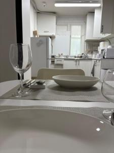 a table with a wine glass and a plate on it at Luna stay in Seoul