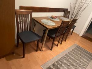a dining room table with four chairs and a table and chairsktop at M&O Belgrade in Belgrade