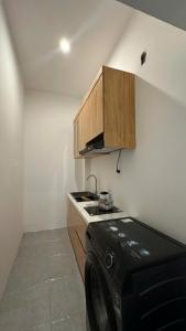 a kitchen with a black microwave and a stove at D'Igel Boutique in Da Nang