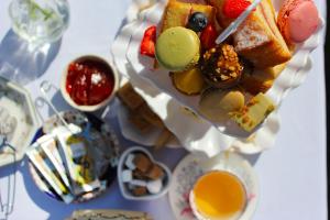 a table topped with a plate of food with desserts at Guestling Hall Hotel in Guestling