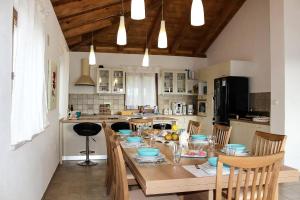 a kitchen with a wooden table with chairs and a dining room at Arton Villa in Žminj