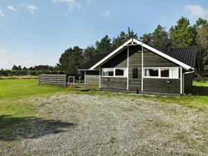 a small house with a gravel driveway in front of it at Cozy Retreat with Spa - By Traum Ferienwohnungen in Stenbjerg