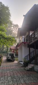 a car parked in front of a house at Coorg Namana homestay in Suntikoppa