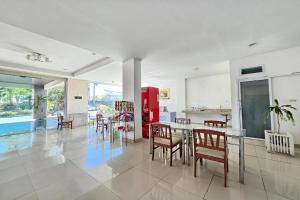 a living room with a table and chairs and a pool at Grand Place Resort in Udon Thani