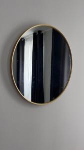 a mirror hanging on a wall with a window at Valdefores139 in Viveiro