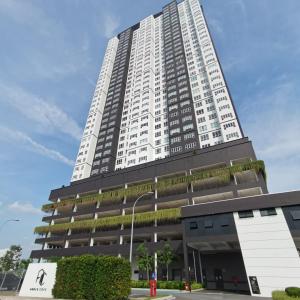 a tall white building with plants on it at Amber Cove in Malacca