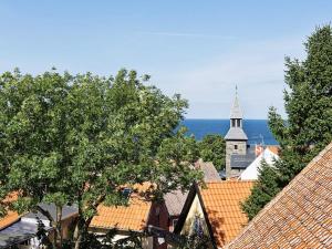 an aerial view of a town with a church and the ocean at 4 person holiday home in Gudhjem-By Traum in Gudhjem
