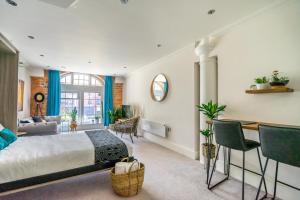 a bedroom with a bed and a living room at York Cocoa Suites - city centre apartments in York