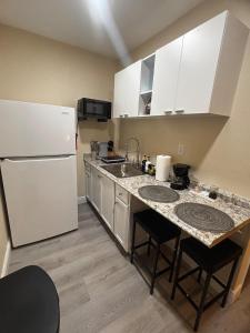 a kitchen with a white refrigerator and a sink at Cozy Stay in Tampa in Tampa