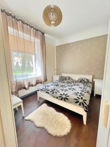 a bedroom with a bed and a window and a rug at Panda House - Luxury in Old Town in Tartu
