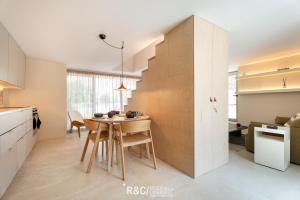 a kitchen with a wooden table and a dining room at Casa Piccadilly - Óbidos Design Villa, Surf & Golf in Sobral