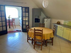 a kitchen and dining room with a table and chairs at Ty kaz plato in Saint-Leu +8 photos