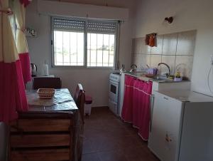 a kitchen with a sink and a stove top oven at Lo Pituco casa de campo in Federación