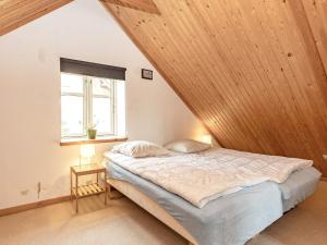 a bedroom with a bed with a wooden ceiling at 6 person holiday home in Marstal in Marstal
