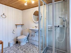 a bathroom with a toilet and a sink and a shower at 6 person holiday home in Marstal in Marstal +18 photos