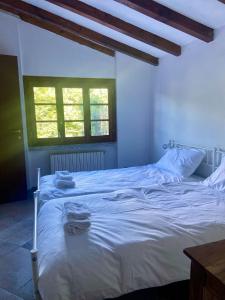 a bedroom with a white bed with towels on it at 2 double rooms apartment- La Casa di Alice in Valbrona