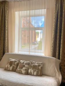 a window with a couch in front of a window at Panda House - Luxury in Old Town in Tartu