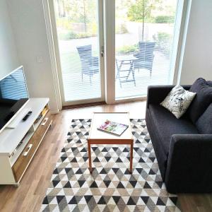 a living room with a couch and a coffee table at Long Journey Helsinki in Helsinki