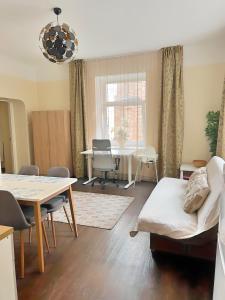 a living room with a table and a couch at Panda House - Luxury in Old Town in Tartu