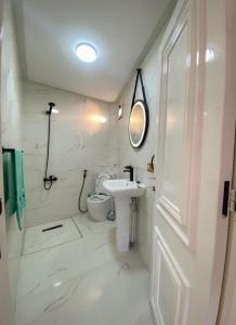 a white bathroom with a sink and a toilet at Casa almas in Chefchaouen +16 photos