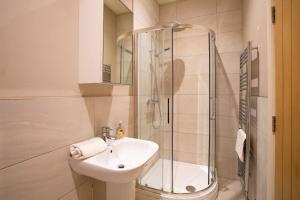 a bathroom with a sink and a glass shower at Boutique Central 2 bed In Harrogate - Sleeps 6 in Harrogate