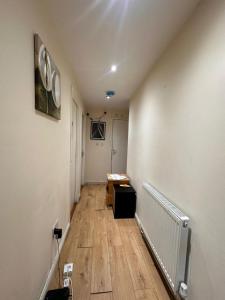 an empty hallway with a desk and a room with a hallway at Small Budget Roomz 2 in Thamesmead
