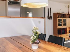 a dining room table with a potted plant on it at 7 person holiday home in Spøttrup in Spottrup