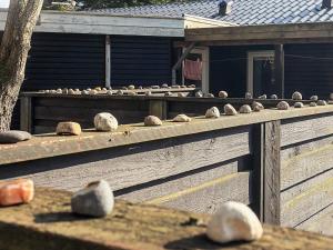 a group of rocks on a wooden fence at Seaside Charm in albaek - By Traum Ferienwohnungen in Spottrup